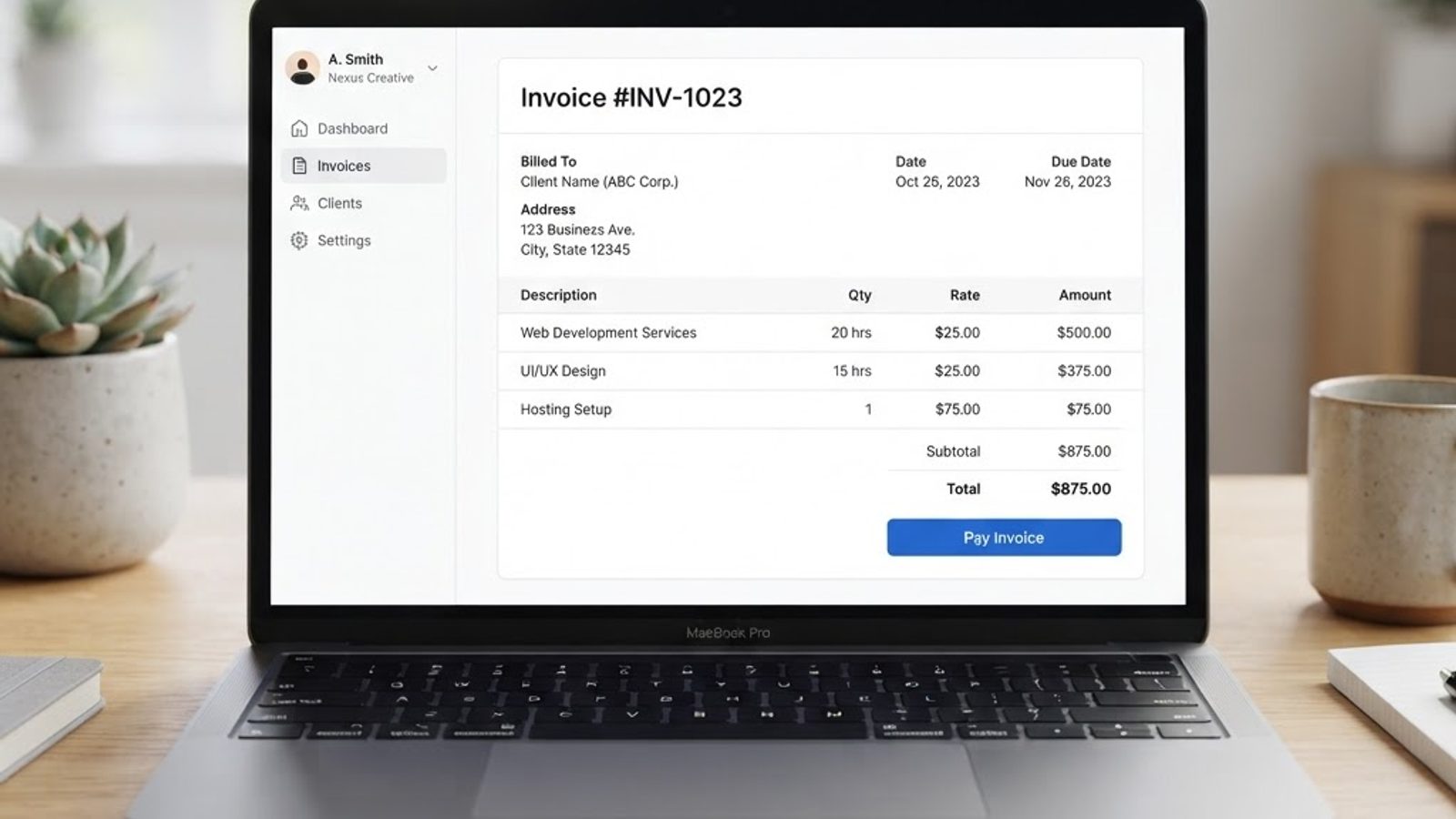 Invoice on a laptop screen with a total and a pay invoice button